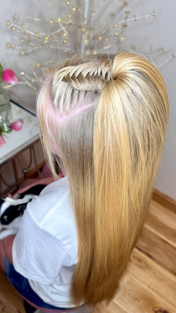 Long blonde hair styled in a crown wrapped half pony ponytail.