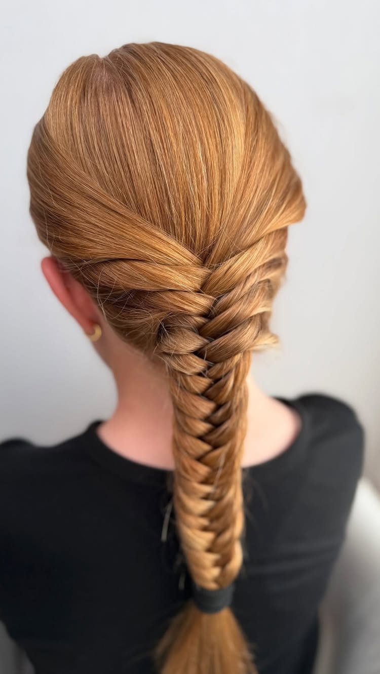 9 Long Hair Tutorial Ideas: Braids, Buns and Ponytails 1 Strawberry blonde hair styled in a long, detailed fishtail braid from behind.