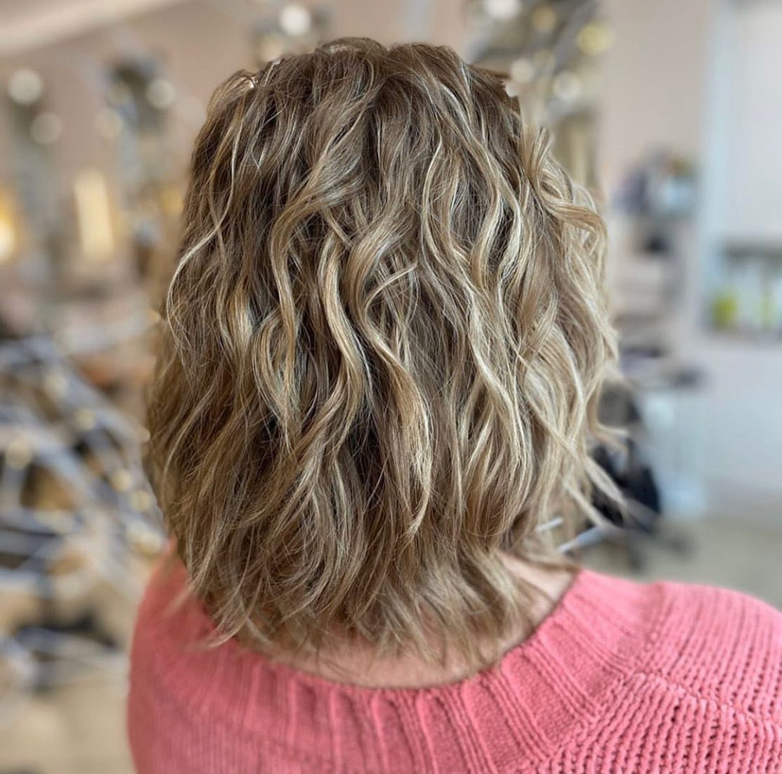 9 Medium Length Perm Hair Ideas with Waves and Curls 5 Medium-length blonde and brown hair with defined wavy curls and highlights.