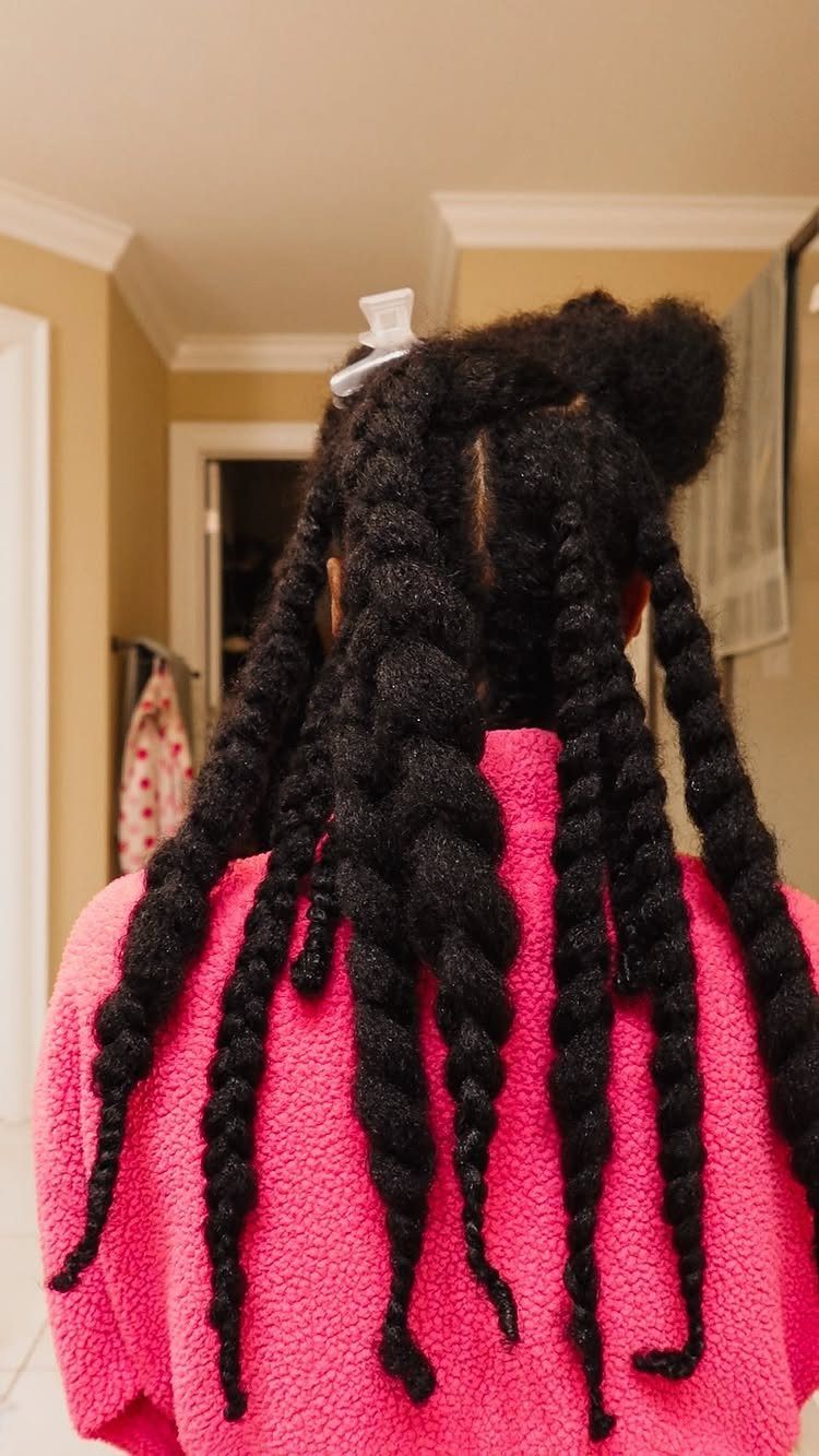 Twisted 4C natural hair on a person wearing a pink textured robe.