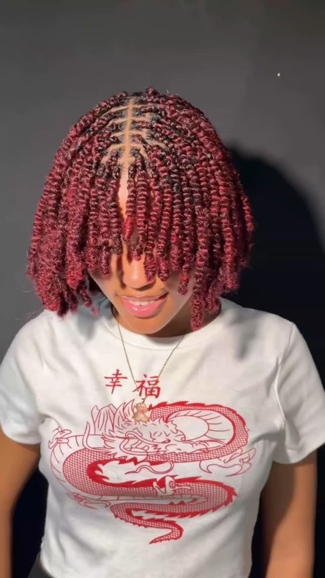Woman with red twisted natural hair in a bob length and white t-shirt