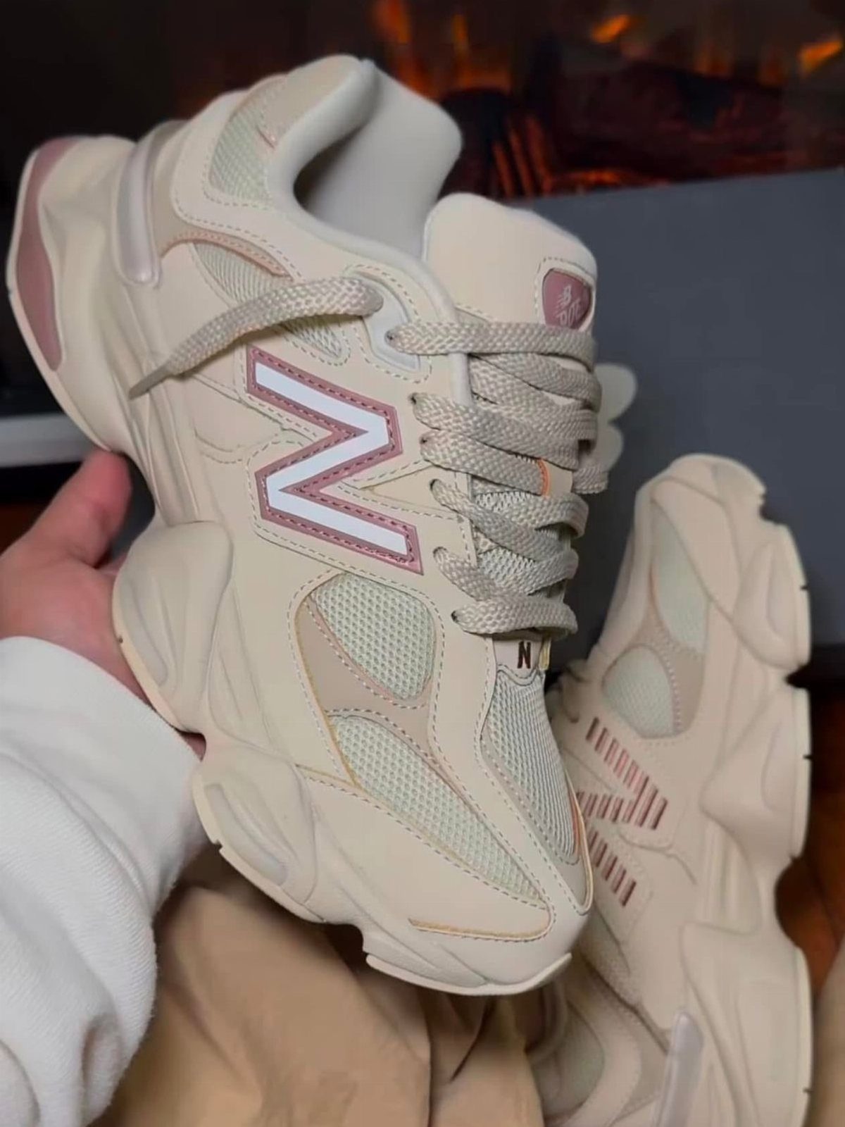 New Balance Shoes Beige: 5 Ideas for Everyday Outfits 5 Beige New Balance sneakers with chunky soles and mesh panels held by a person