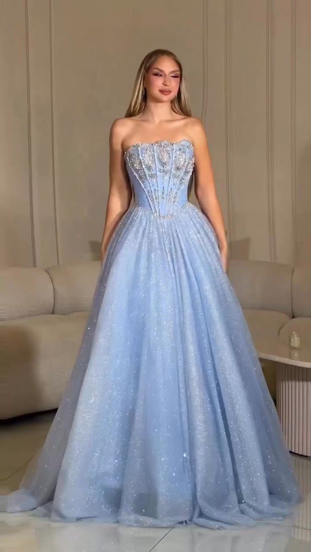 10 Nice Prom Dresses for Every Style and Body Type 3 Woman in a voluminous light blue glittery ball gown with a beaded bodice.