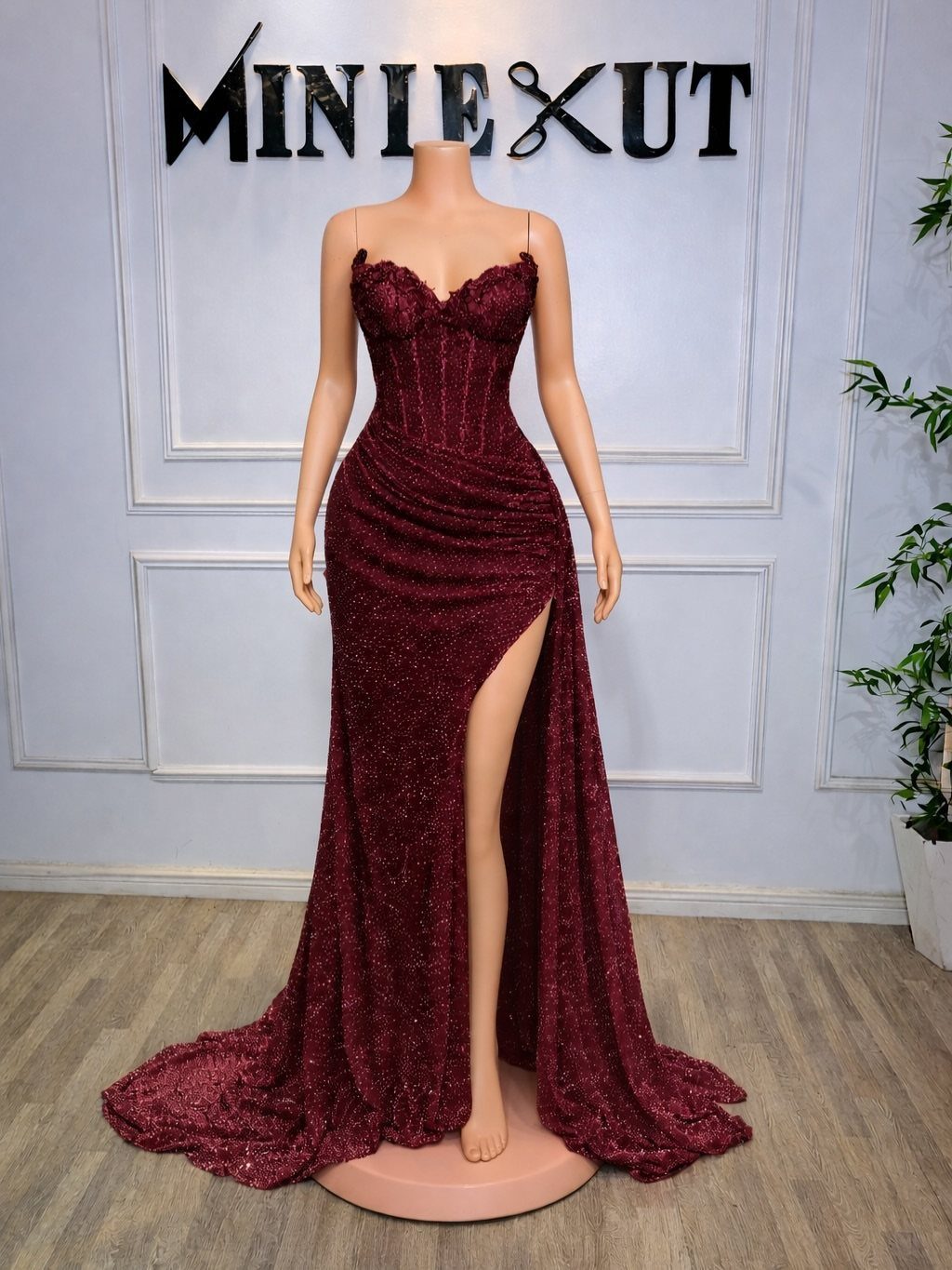 10 Nice Prom Dresses for Every Style and Body Type 9 Burgundy sparkling long prom dress with a high slit on a mannequin