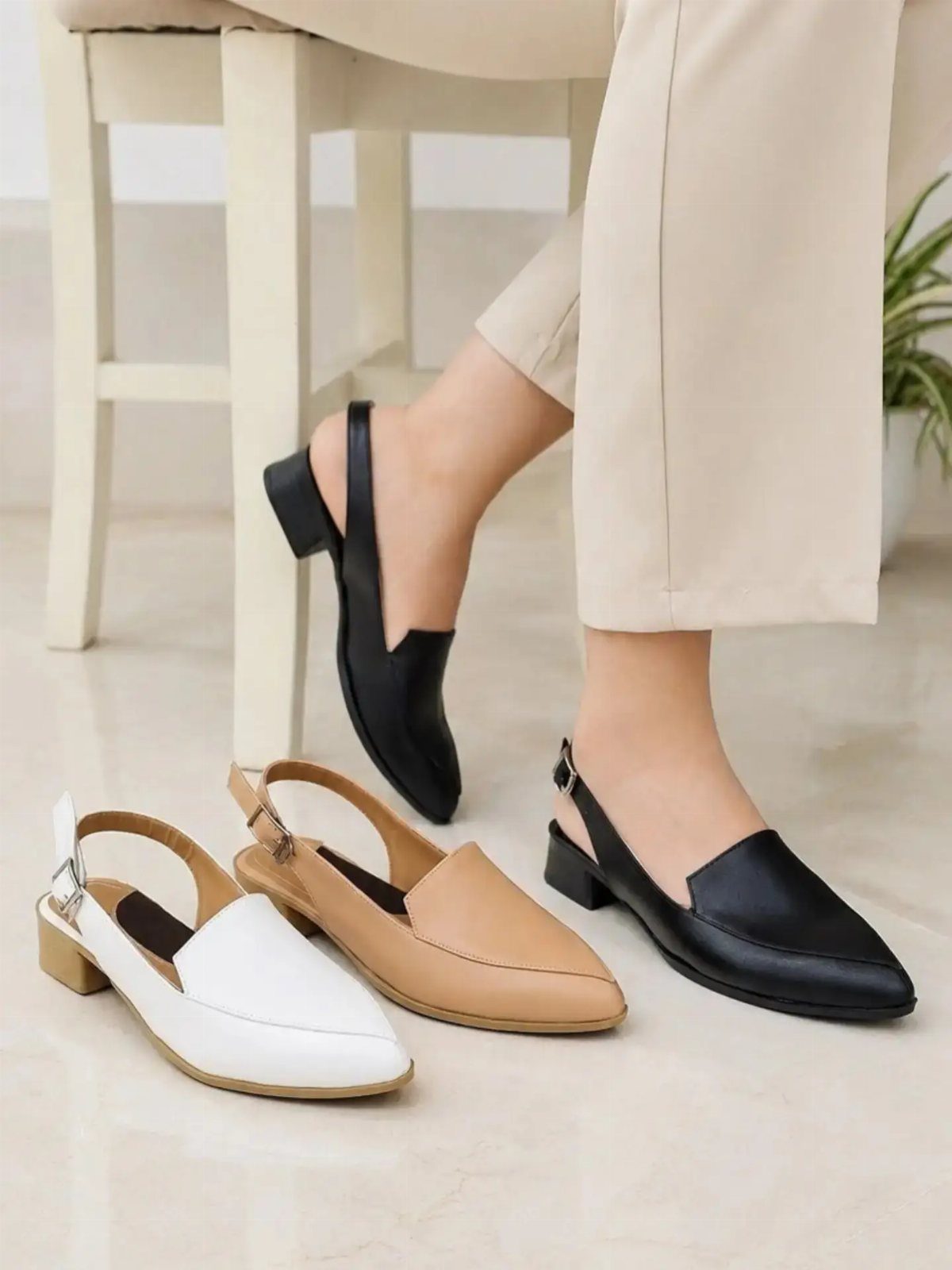 Night Out Shoes: 12 Styles From Flats to Stilettos 11 Black, white, and tan slingback pointed-toe heels worn and displayed on a floor.