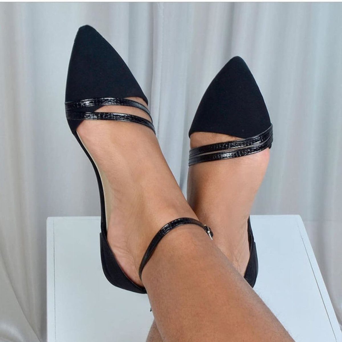 Night Out Shoes: 12 Styles From Flats to Stilettos 10 Black pointed-toe high heels with ankle straps worn on a person's feet.