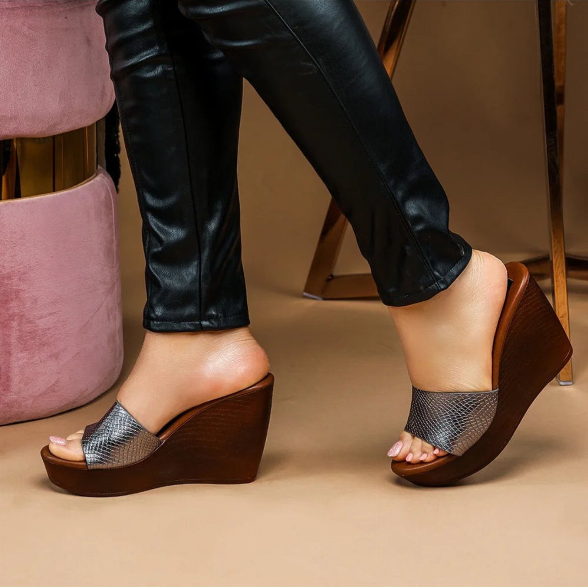Night Out Shoes: 12 Styles From Flats to Stilettos 7 Brown wooden wedge sandals with silver straps worn with black leather pants.