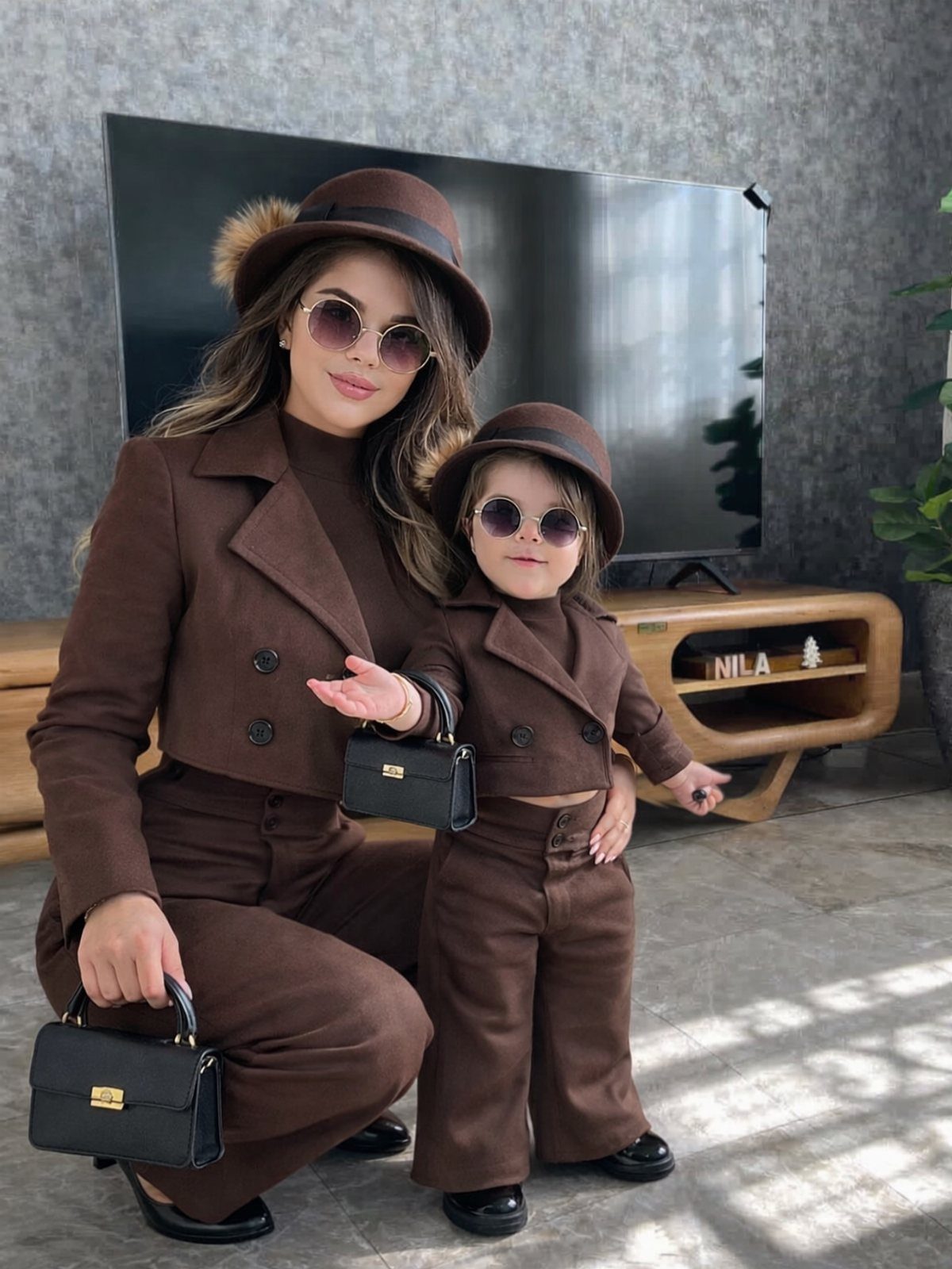Old Fashion Designers and 3 Ideas They Made Classic 2 Woman and young girl wearing matching brown suits, hats, and sunglasses posing together.
