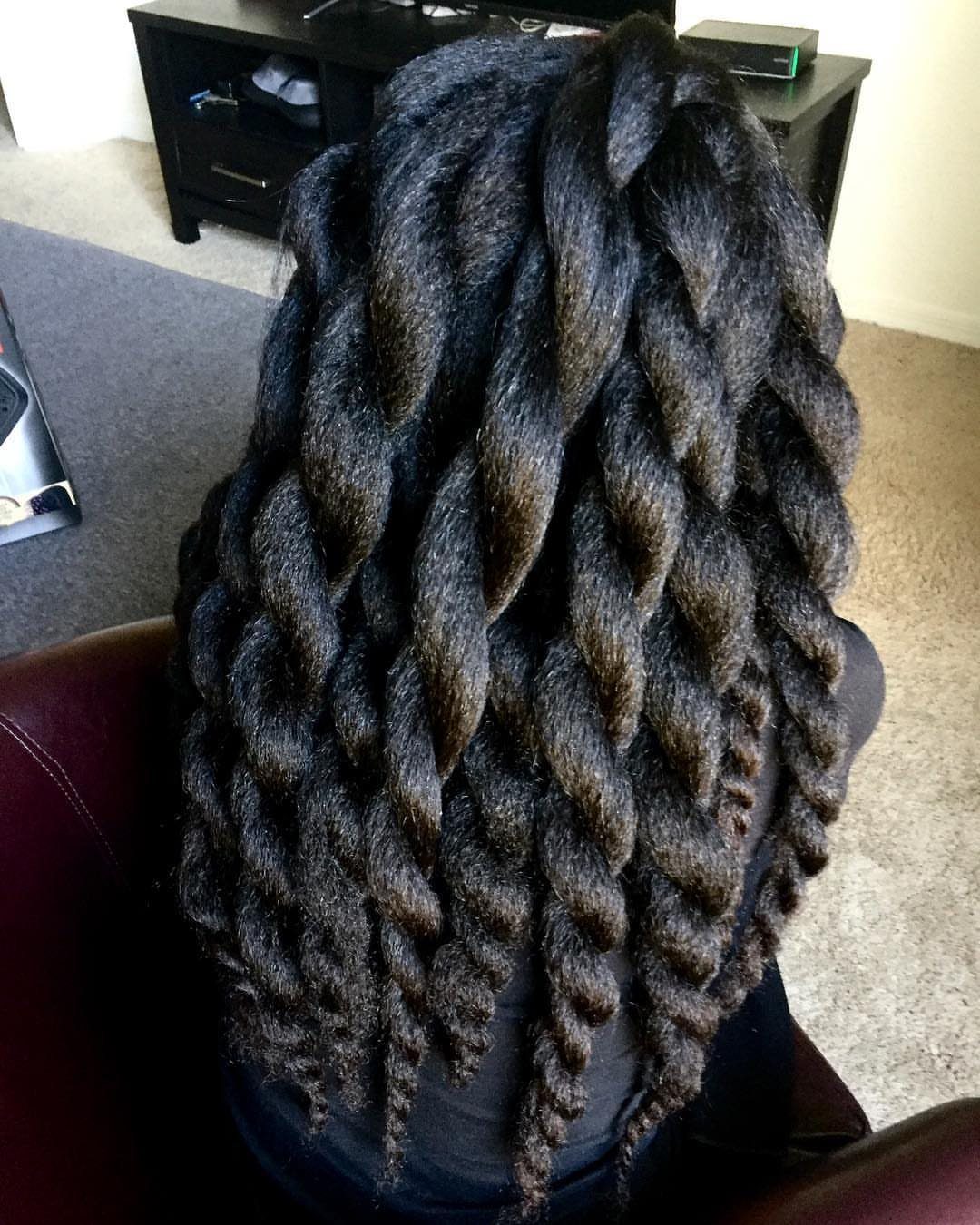 Thick black jumbo passion twists falling down the back of a person.