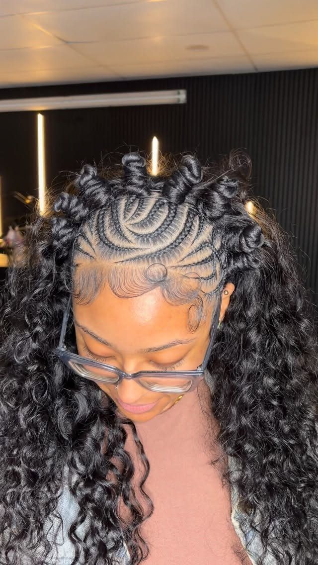 14 Protective Hairstyles with Braids and Twists to Try 4 Woman with cornrow braids ending in small spiraled Bantu knots and long curls.