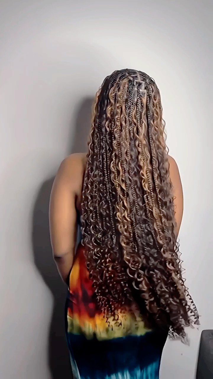 14 Protective Hairstyles with Braids and Twists to Try 8 Long brown and blonde bohemian braids with curly ends on a person.