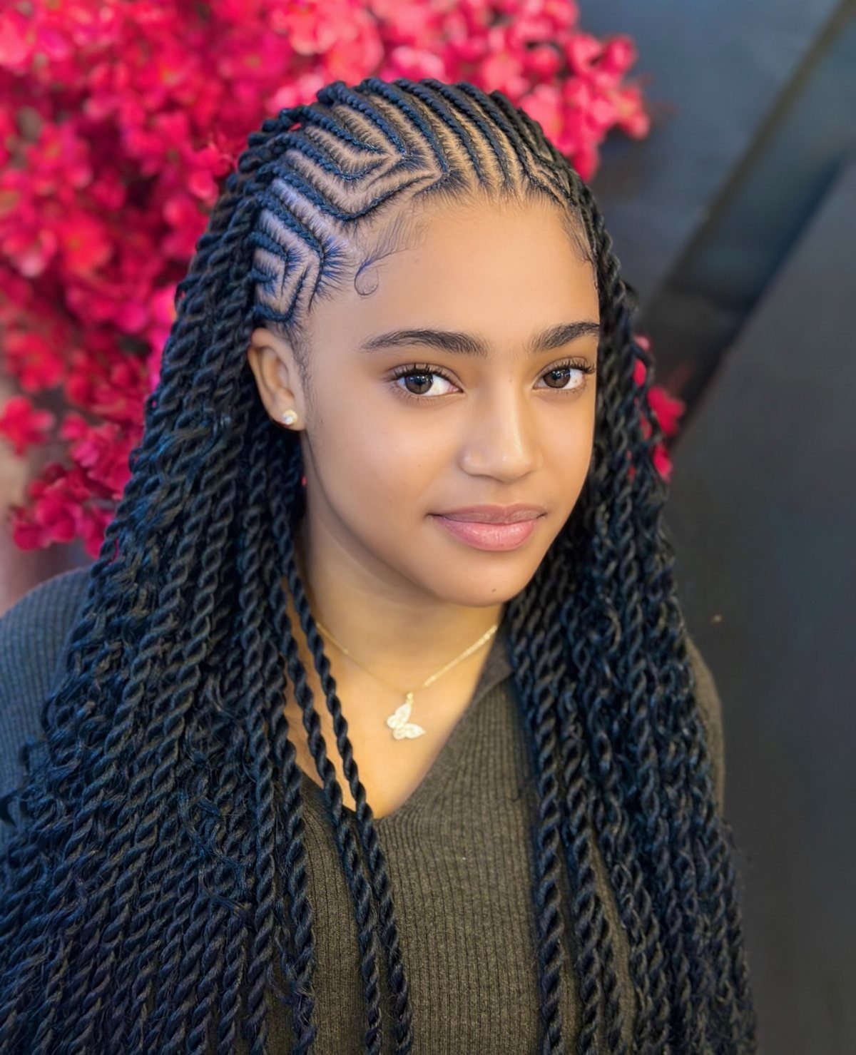 14 Protective Hairstyles with Braids and Twists to Try 1 Woman with intricate cornrow patterns on top and long twists falling over shoulders.