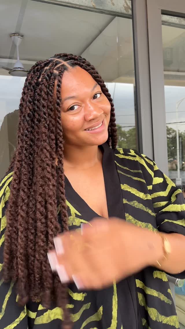 14 Protective Hairstyles with Braids and Twists to Try 13 Woman with long brown Marley twists wearing a green and black zebra-print robe.