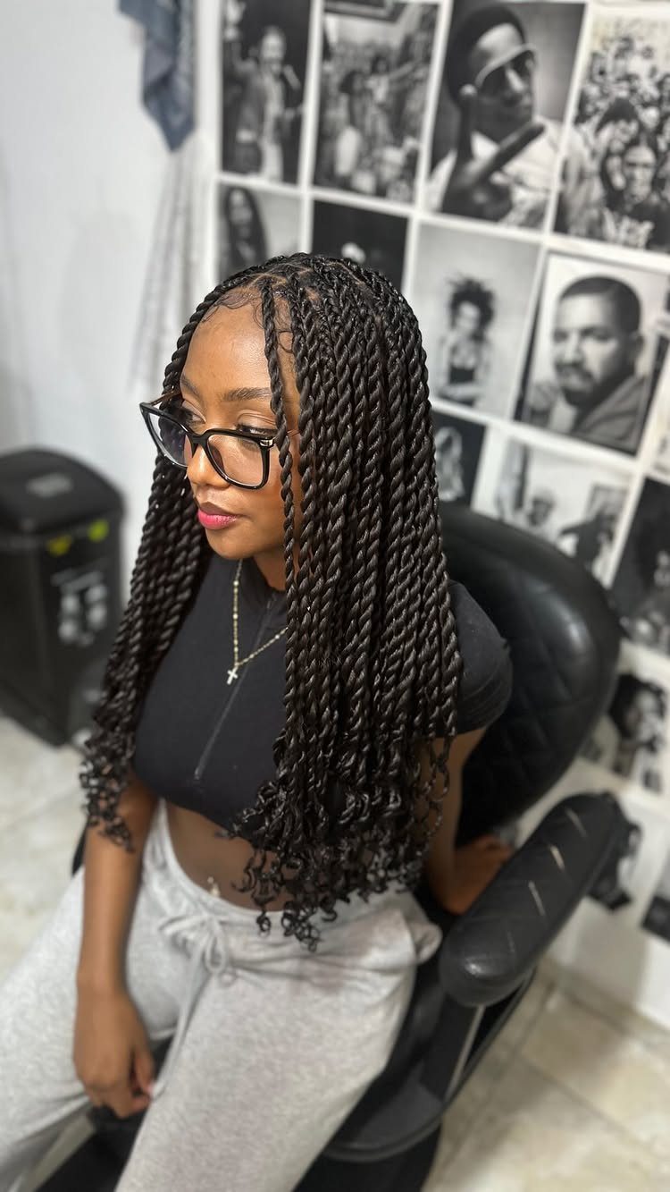 14 Protective Hairstyles with Braids and Twists to Try 5 Woman with long black Senegalese twists sitting in a salon chair.