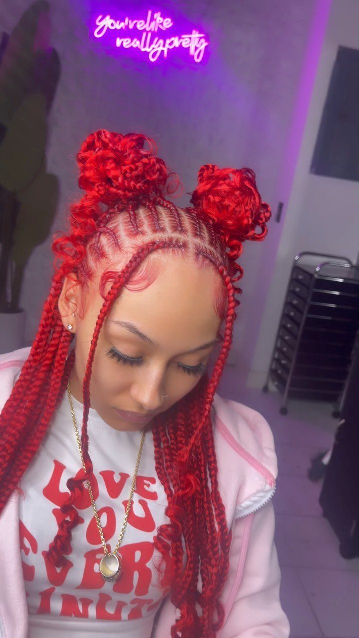 14 Protective Hairstyles with Braids and Twists to Try 11 Woman with red braided hair styled into two high space buns and long braids.