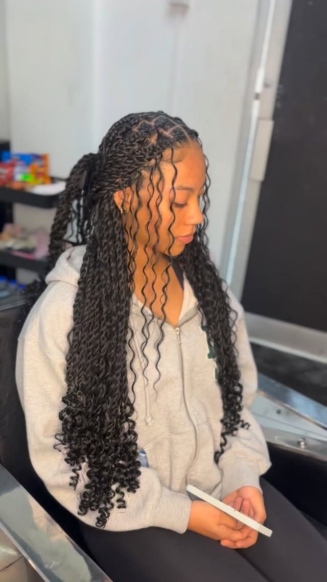 14 Protective Hairstyles with Braids and Twists to Try 14 Woman with long black two-strand twists and curly hair framing her face.