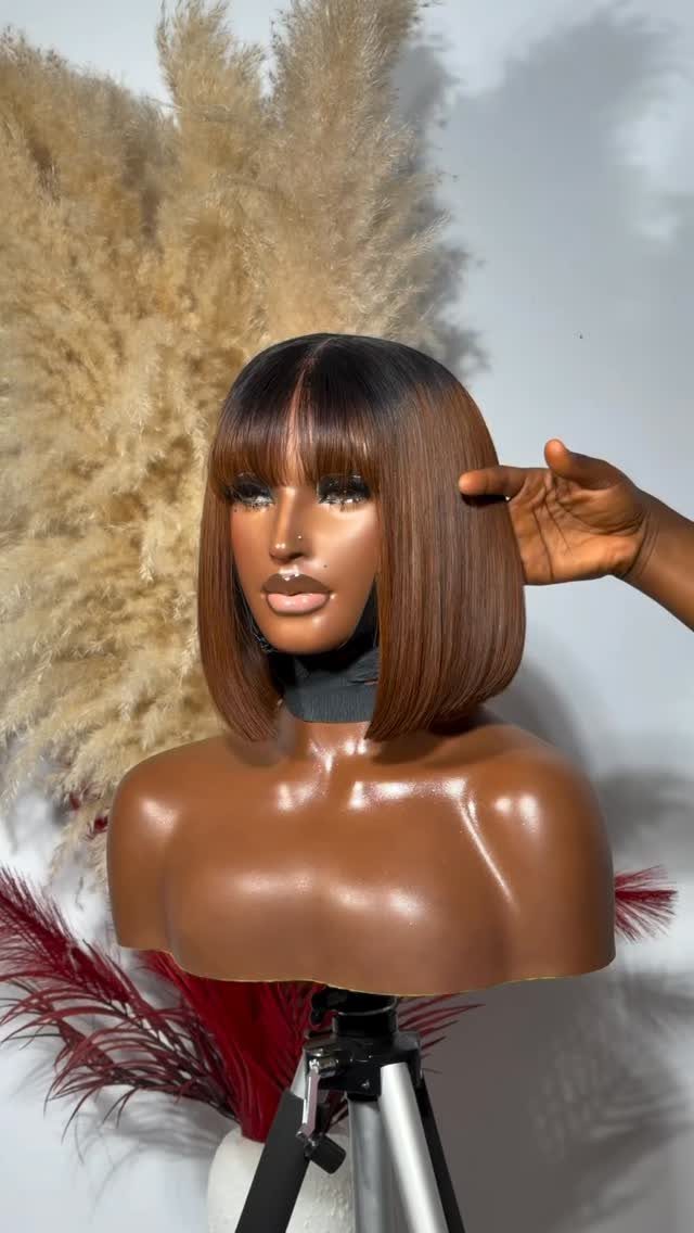 Brown bob wig with golden highlights and bangs on a mannequin head