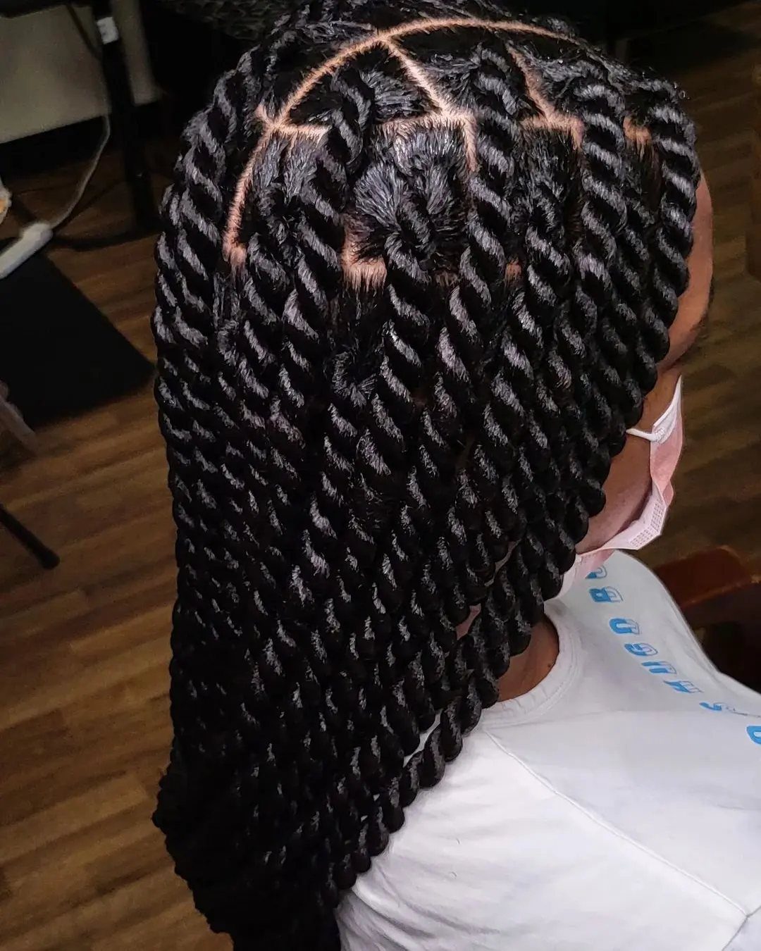 Thick chunky two strand twists on a person with black hair and scalp visible.