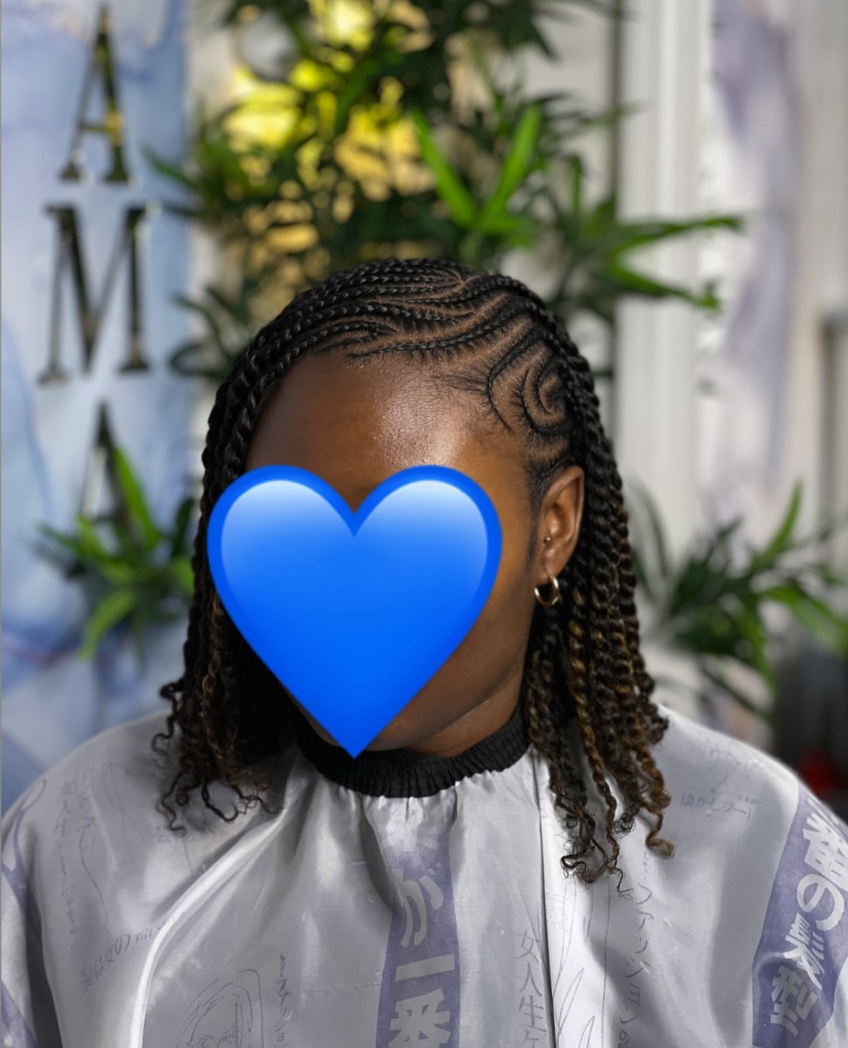 Person with flat twists on top transitioning into two strand twists hanging down.