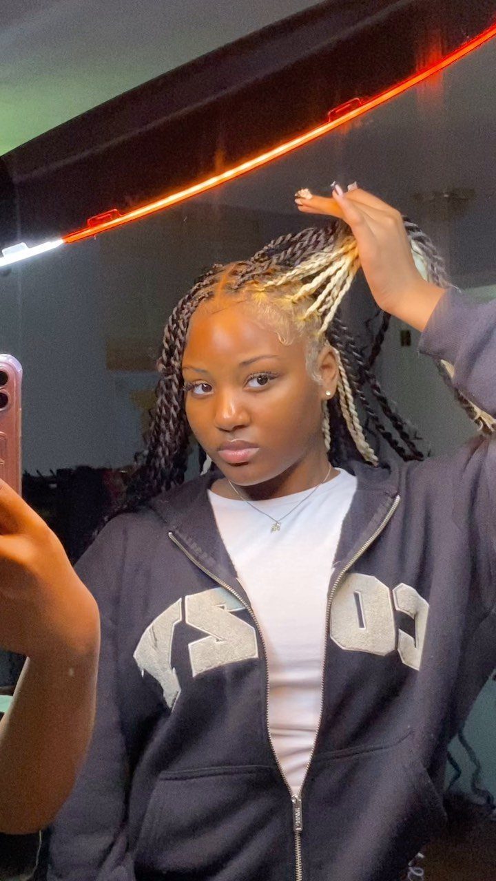 Woman with two strand twists featuring a mix of blonde and dark brown colors.