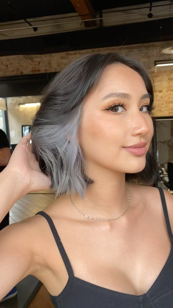 Types of Hair Colour: 12 Ideas, From Balayage to Copper 7 Woman with short wavy ash gray hair wearing a black top and necklace.