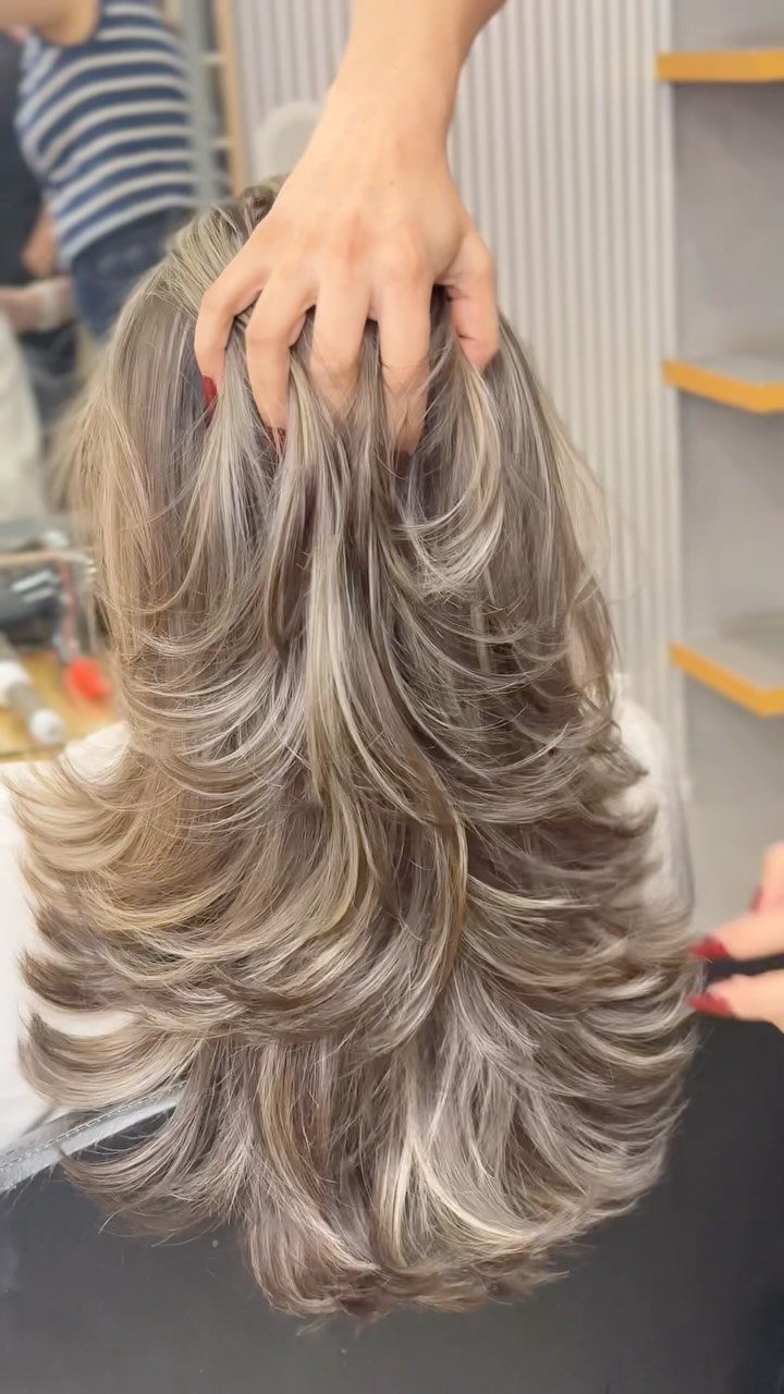 Types of Hair Colour: 12 Ideas, From Balayage to Copper 2 Layered ash-blonde hair with bright highlights being styled by a professional hairdresser.