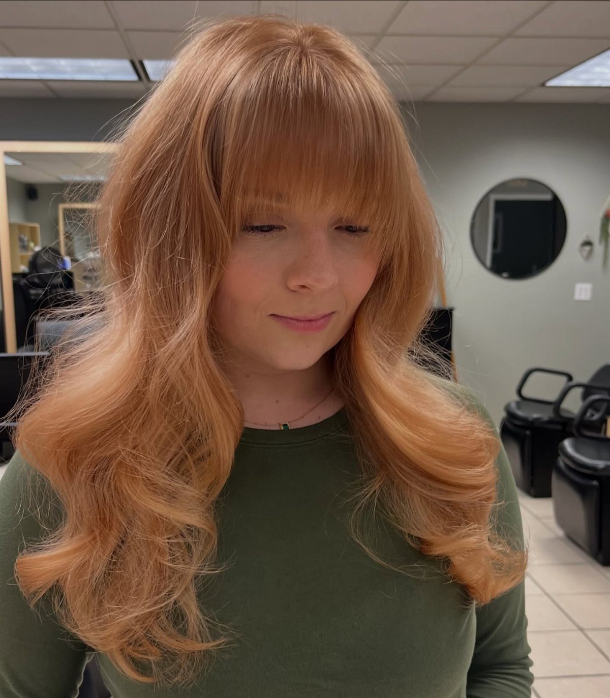 Types of Hair Colour: 12 Ideas, From Balayage to Copper 12 Woman with long wavy strawberry blonde hair and bangs in a salon setting