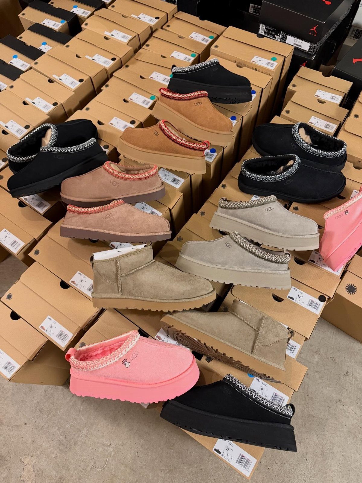 Uggs with Designs: 5 Ideas, From Leopard Print to Bows 4 Rhinestone decorated sheepskin boots in various colors resting on cardboard shoe boxes.