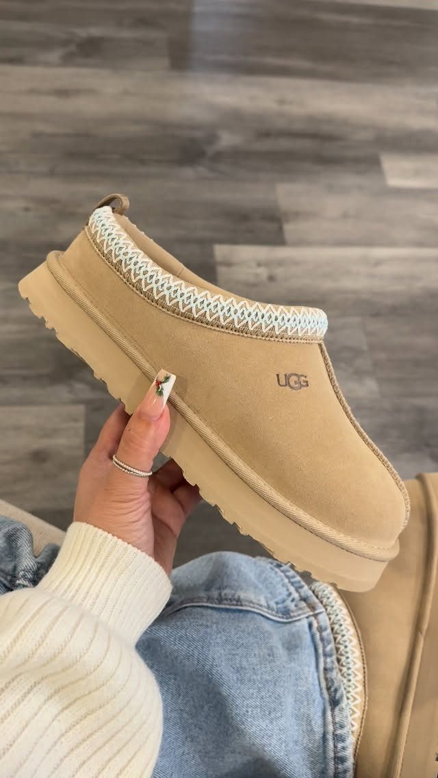 Uggs with Designs: 5 Ideas, From Leopard Print to Bows 1 Tan suede UGG Tazz platform slipper with braided trim held by a person.