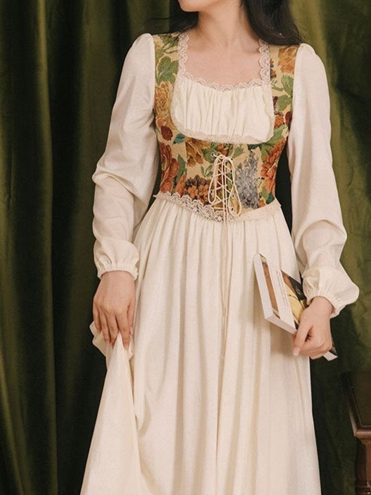Woman in a cream Victorian-style gown with floral bodice holding a book