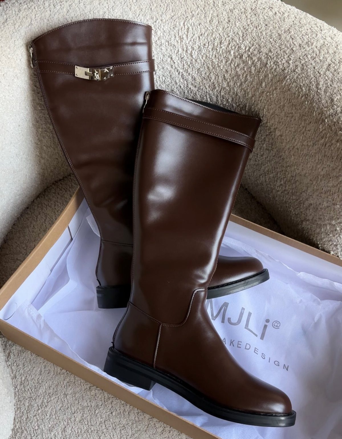 Winter Boots 2026: 8 Styles, From Slouchy to Shearling 8 Brown polished leather tall boots resting inside a white and brown shoebox.